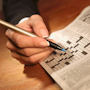Cryptic Crossword Workshops Photograph of a man completing a crossword