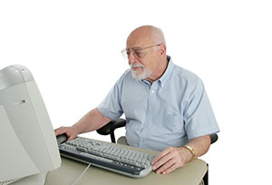 male sitting behind computer