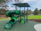 Shaded play equipment and slide