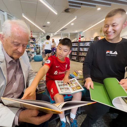 Hornsby Shire Mayor enjoys reading with Oscar and his dad at Hornsby Central Library