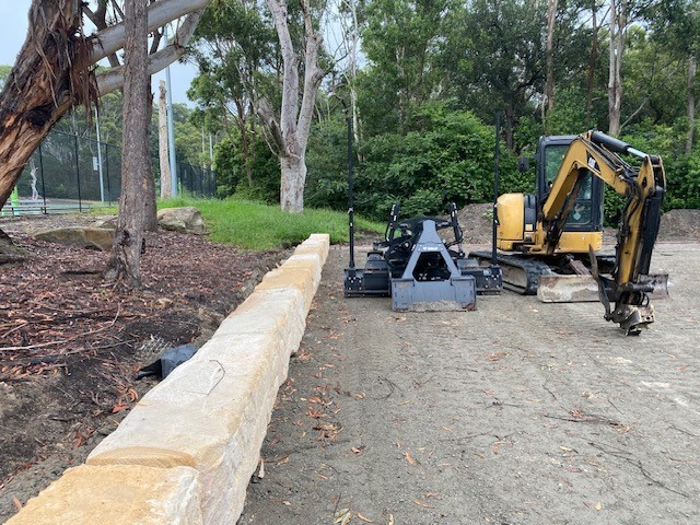 stone wall with digger in background