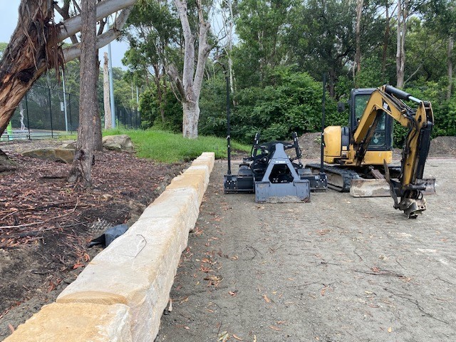 stone wall with digger in background