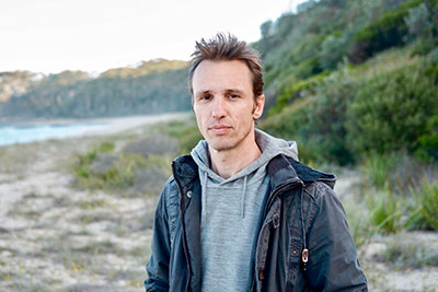 author standing near beach