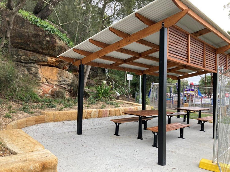 Shelter with wooden tables