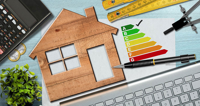 Energy efficiency rating graph on a desk with a wooden house model