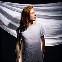 Andy Freeborn standing against white sheet