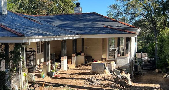 house with rubble out front