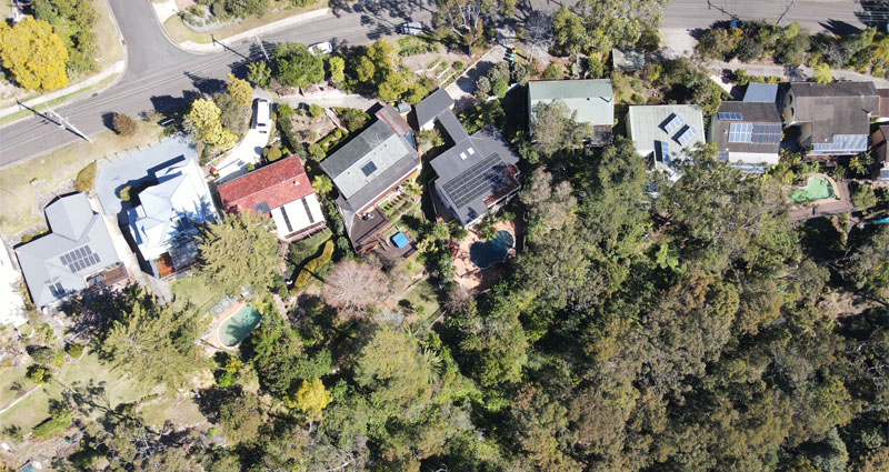 aerial of houses meet bushalnd