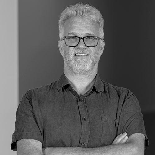 Tim standing with folded arms