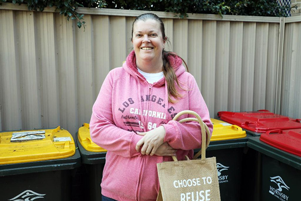 female in front of bins