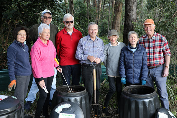 Group standing in front of compost bins