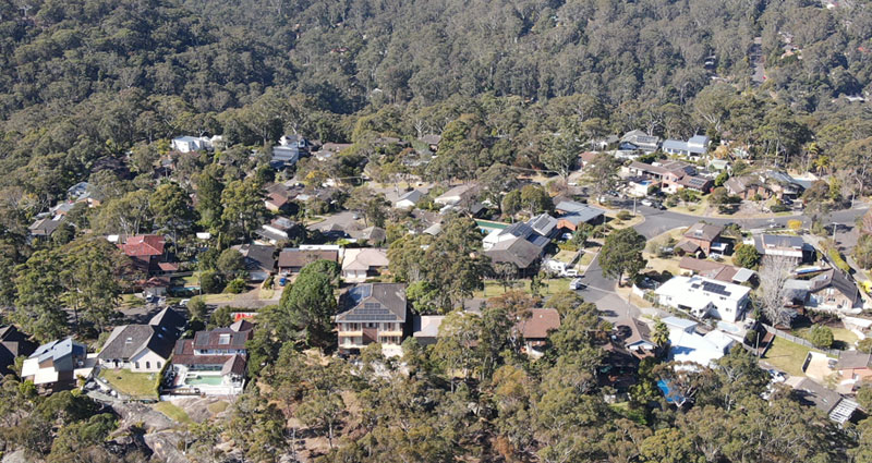 aerial of houses surrounded by bush