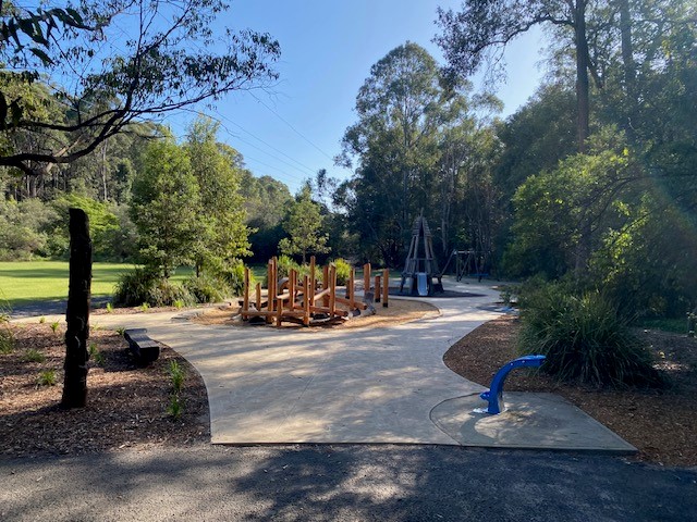 playground with concrete path in foreground