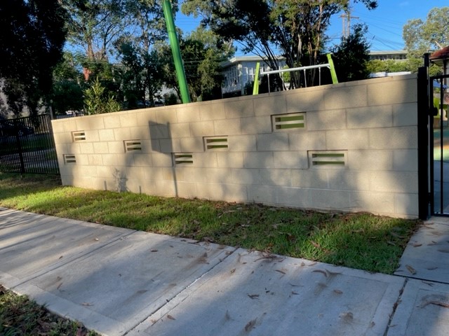 wall with playground behind