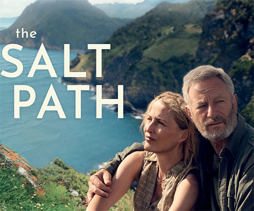 man and woman sitting near cliff face