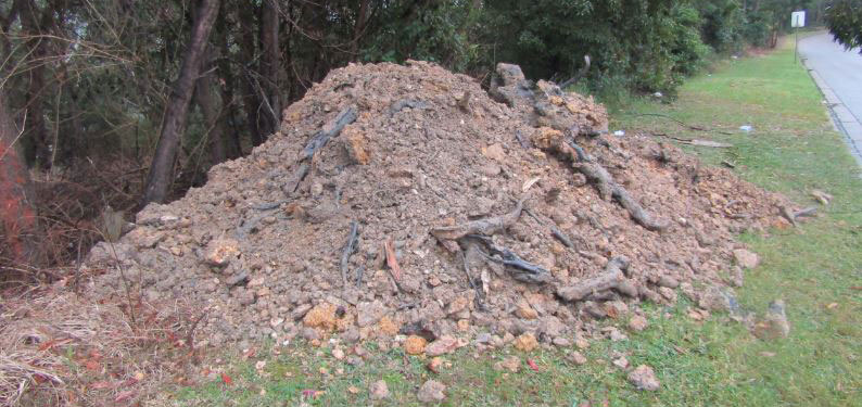 Pile of dirt on side of road