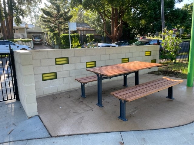 wall with table and bench beside