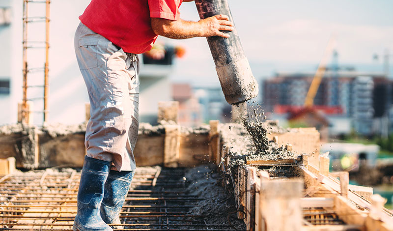 Worker pouring concrete details