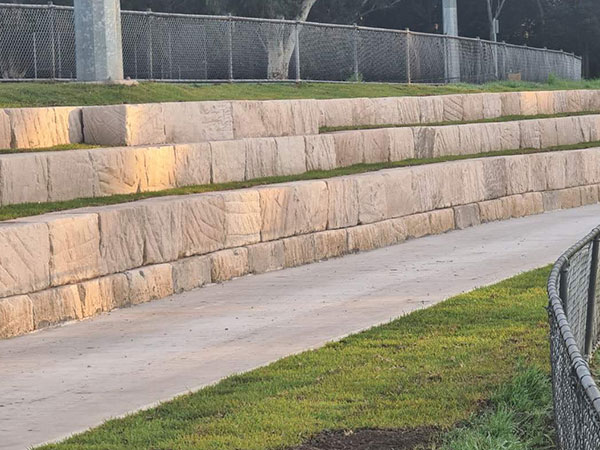 path with stone wall and fence