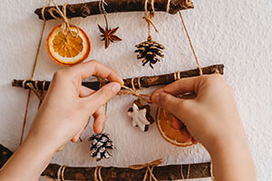 hands with sticks and string crafting