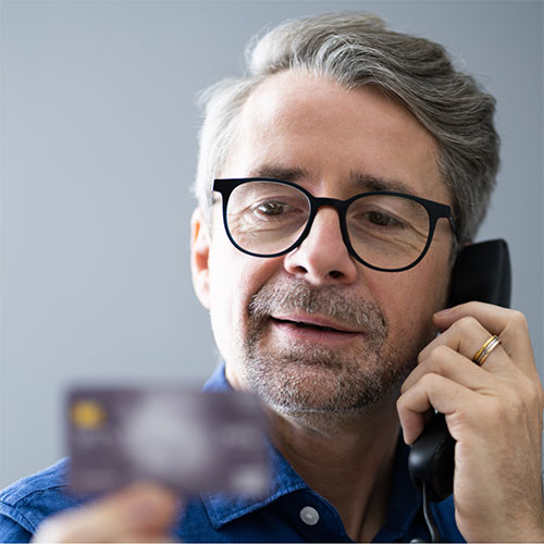 man on phone with credit card