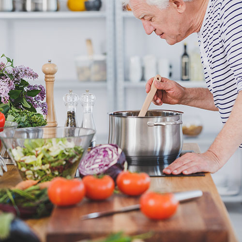 elderly man cooking