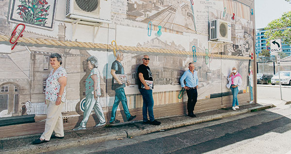 people in front of mural