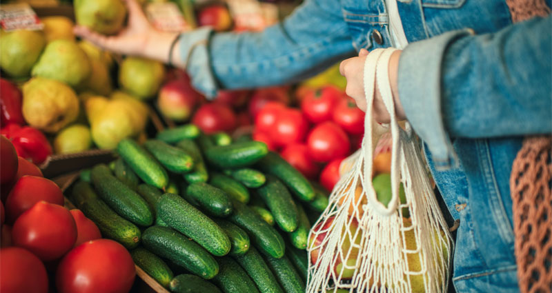 Shopping for vegetables with reusable bag