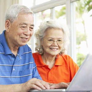 Elderly couple in front of computer