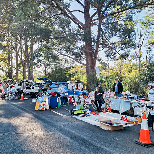 people on road with stuff for sale