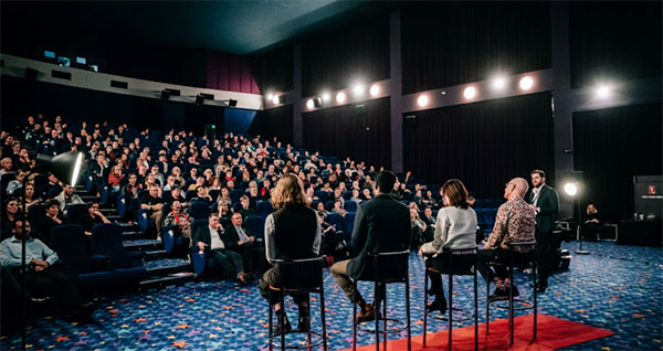 crowd in hall with speakers