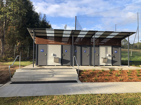 new amenities block with concrete path and landscaping