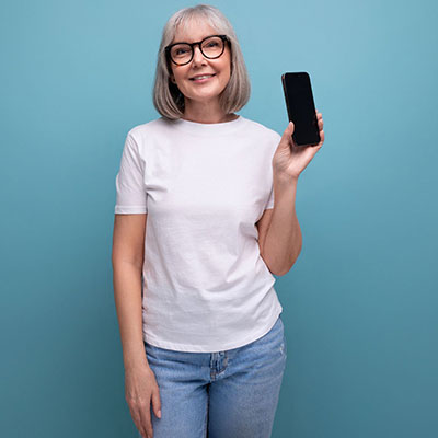 female in white teeshirt holding up phone
