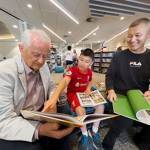 Hornsby Shire Mayor enjoys reading with Oscar and his dad at Hornsby Central Library