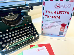 old typewriter on table with letter to Santa beside