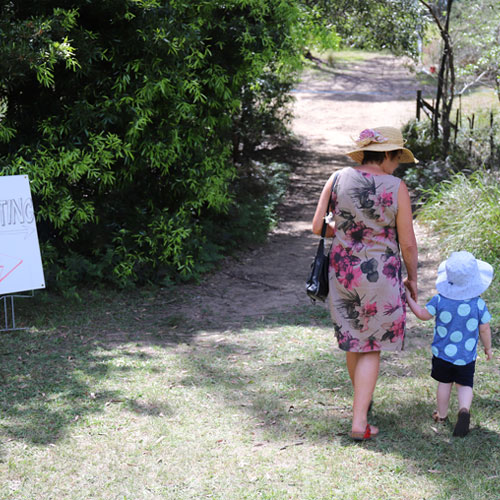 mum and child walking to planting area