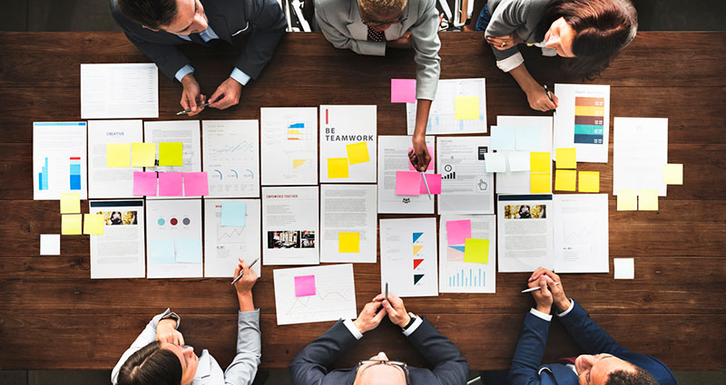 Group around table planning with paper and notes