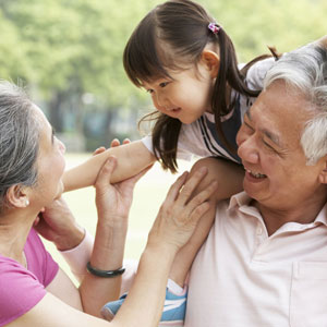 Asian couple. Man has young girl on shoulder