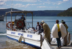 Volunteers loading bags of collected weeds on to the barge