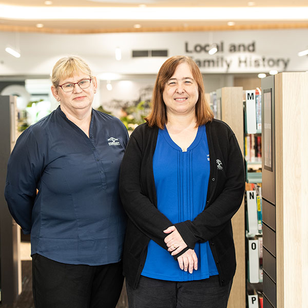 females standing at entrance to library