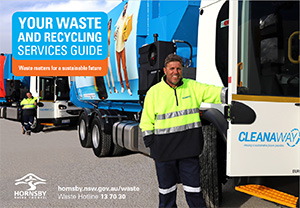 worker standing next to bin truck