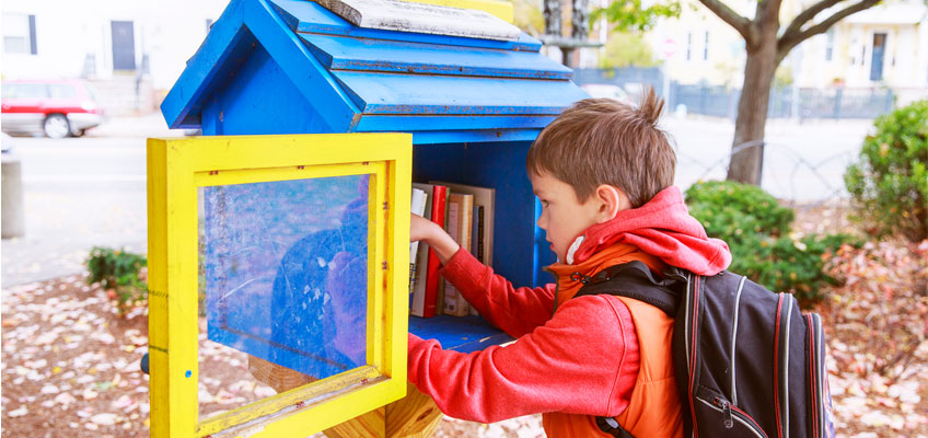 Street Library and boy getting book