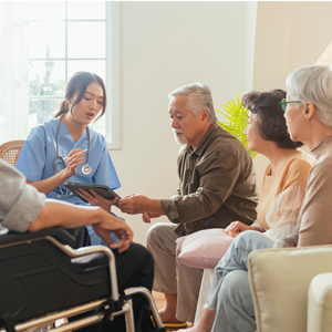  Cheerful elderly woman and men talking with female caregiver nurse doctor having health checking consult at living area,