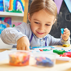 young girl playing at table