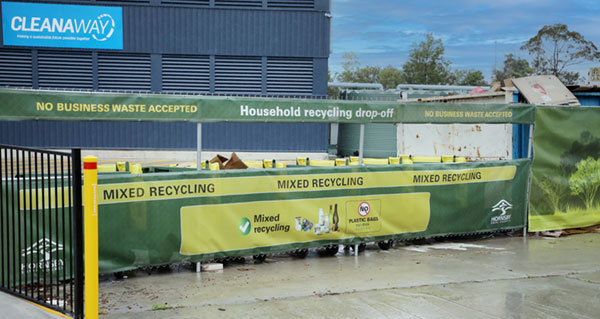 commercial building with banner out front saying mixed recycling