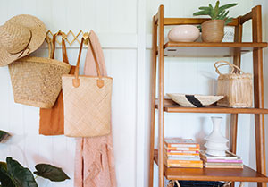 baskets hanging on wall beside storage shelves