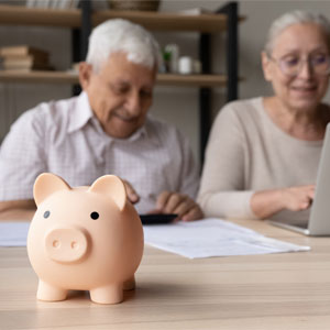Couple calculating finances with piggy bank