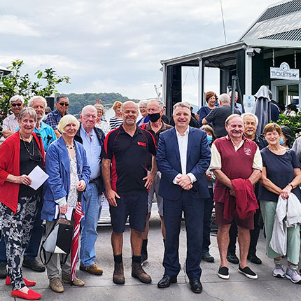 Group in front of boat and booth