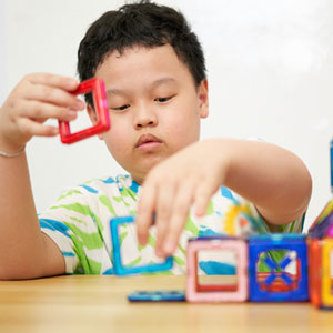 child playing with magnets